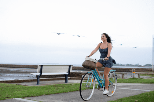 bike basket on cruiser bike next to beach